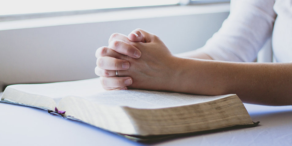 Eine Frau liest die Bibel und betet. Symbolfoto: pixabay.com