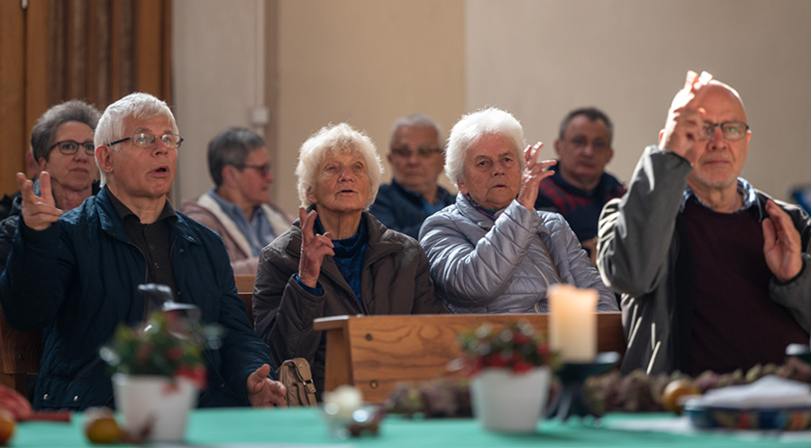 Gehörlose Gläubige „beten“ während eines Gottesdienstes in der Herz-Jesu-Kirche im Bistum Trier, der bundesweit einzigen Pfarrei von Gehörlosen in der katholischen Kirche. Foto: Picture Alliance/dpa/Harald Tittel