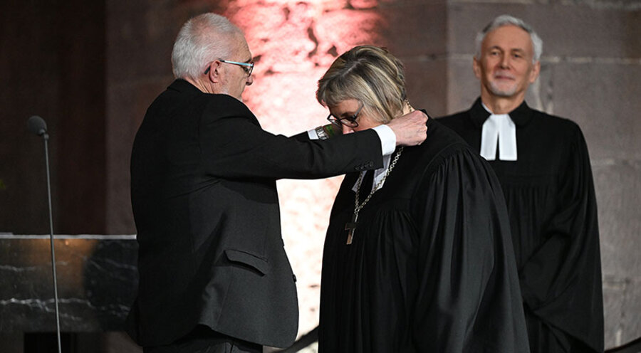 Der Synodalpräsident Axel Wermke hängt Heike Springhart das Bischofskreuz um. Foto: ARTIS/ Uli Deck
